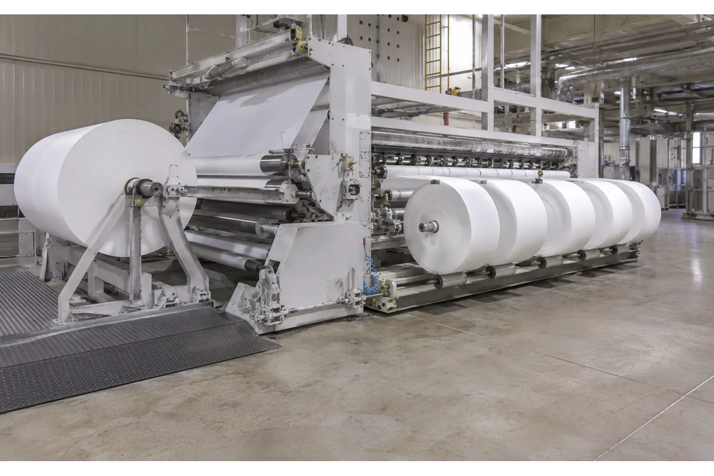Spunlace nonwoven parent roll unwinding through a slitting and rewinding line into multiple soft finished rolls